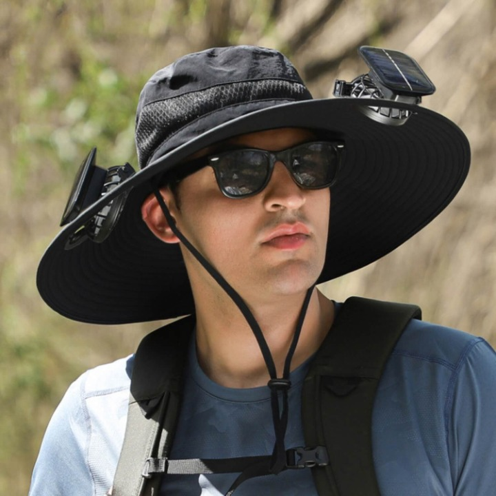 Unisex solar-powered cooling fan hat with wide brim for UV protection, shown outdoors.
