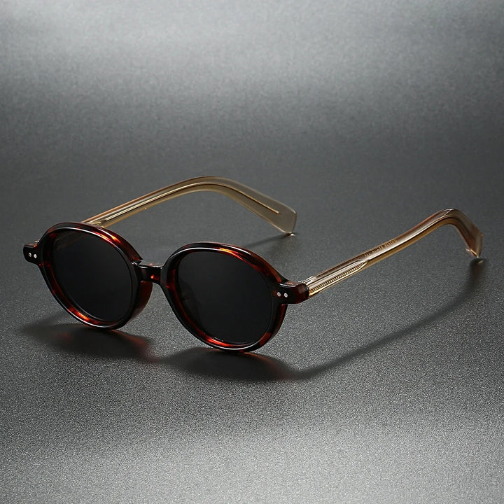 Fashionable unisex tortoiseshell round sunglasses, offering full UV protection. Stylish modern retro eyewear.