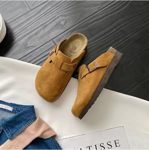 Cushioned unisex slip-on shoes, made of suede, with an adjustable buckle for a custom fit.