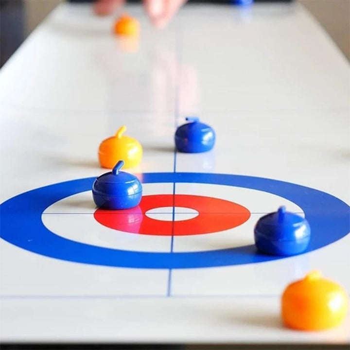 Close-up of vibrant red and blue stones on the felt mat of the Unisex Tabletop Curling Game.