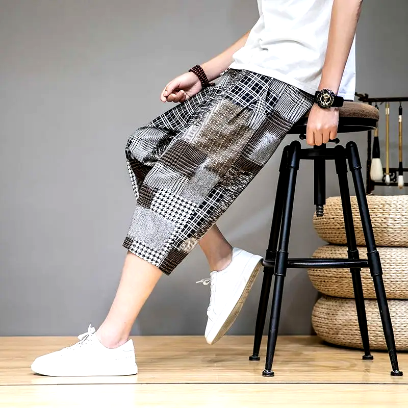 Stylish unisex capris shorts with a distressed patchwork design & elastic waist. Perfect for trendy streetwear.