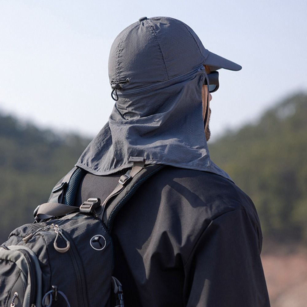 Blue trucker hat with integrated neck flap, offering excellent UV protection for outdoor gear.