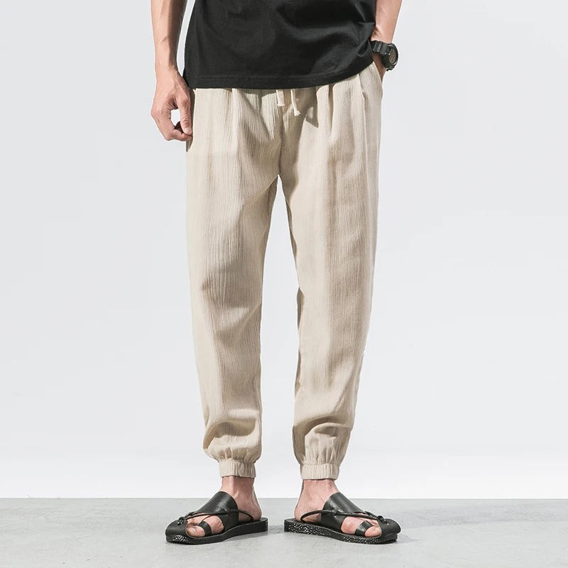 Relaxed fit unisex joggers, ultra-light cotton blend, offering comfort for athletic and casual wear.