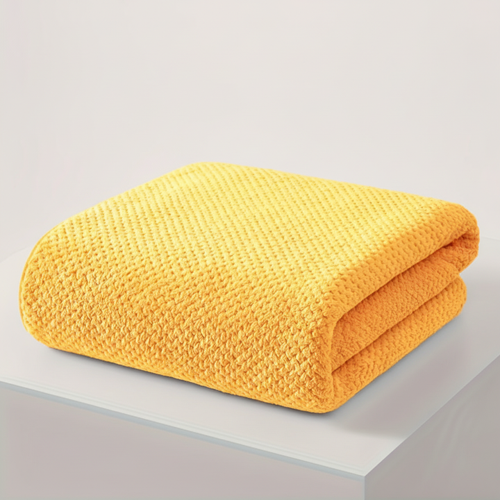 Compact folded microfiber bath towel, ideal for travel or home, absorbent and soft