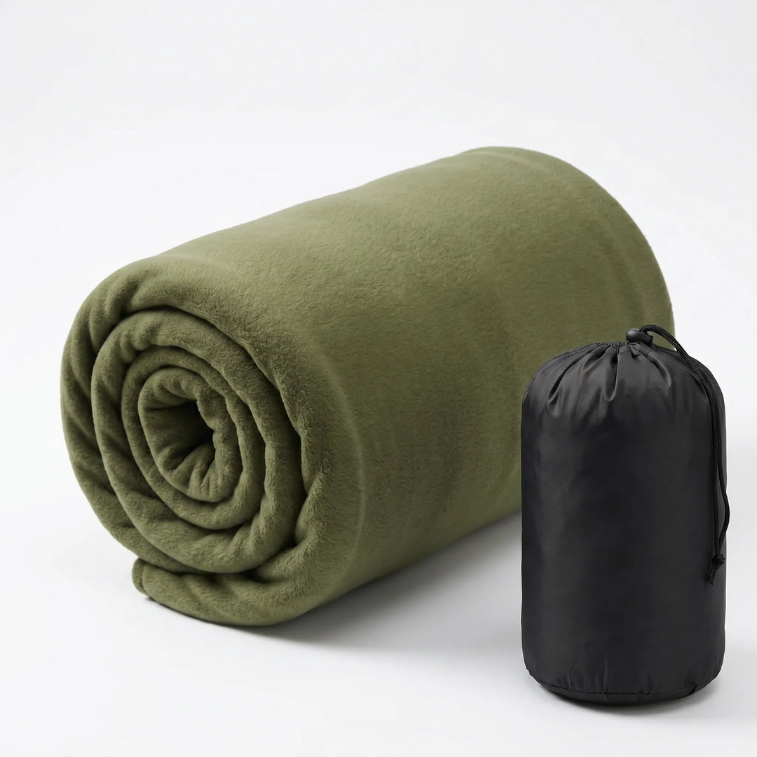 Ultralight fleece sleeping bag liner flat lay with camping gear. Portable, cozy addition for outdoor adventures.