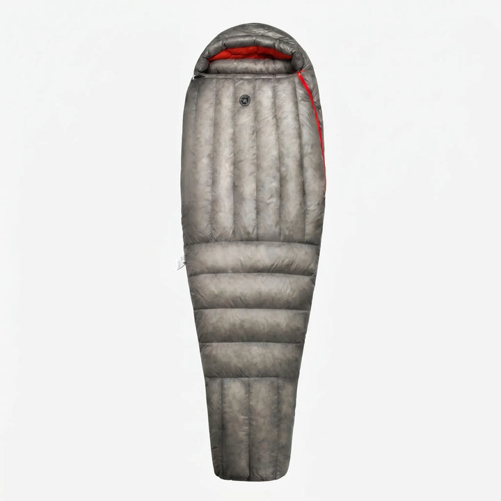 Packed ultralight mummy down sleeping bag, compact for backpacking and travel. Essential three-season camping gear.