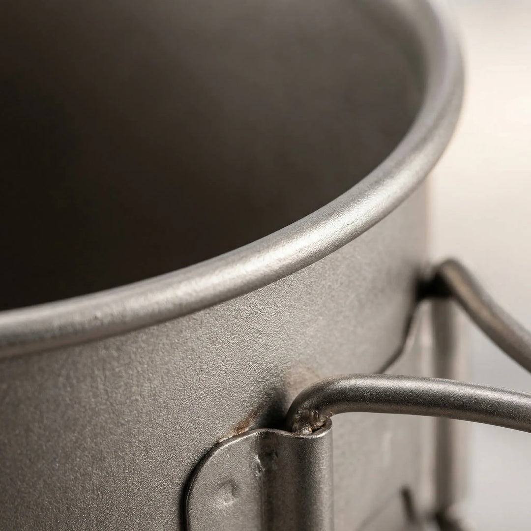Compact ultralight titanium camping cookware set, perfect for backpacking & hiking. Nested pot, mug & spork for travel.