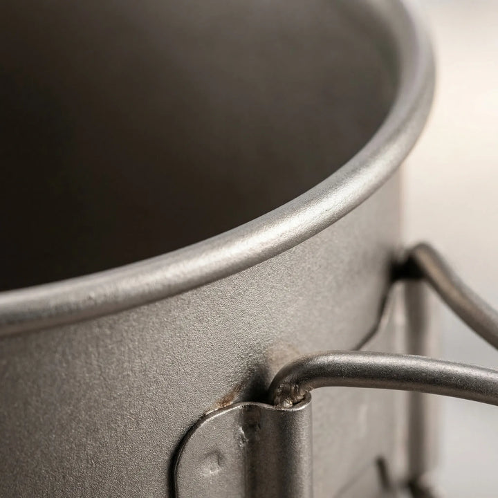 Compact ultralight titanium camping cookware set, perfect for backpacking & hiking. Nested pot, mug & spork for travel.