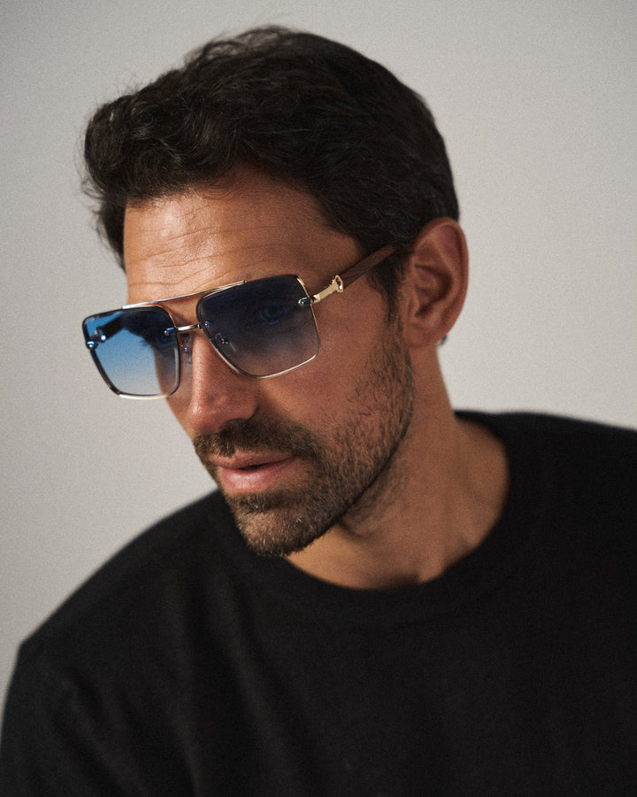 Trendy unisex square sunglasses with multi-color lenses, woodgrain arms, and urban vintage style.