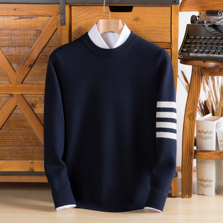 Comfortable unisex knit pullover featuring distinctive striped sleeves and a classic varsity style, relaxed fit.