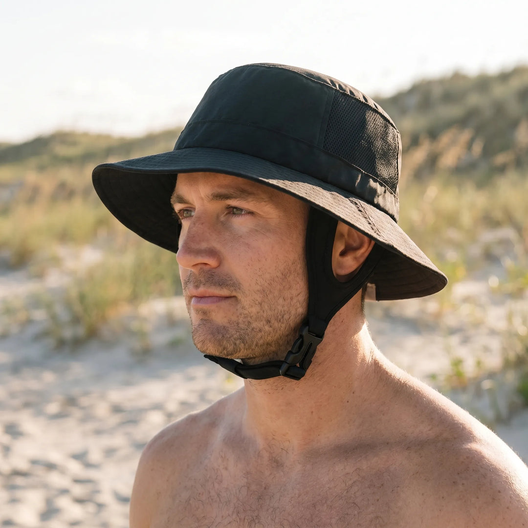 Unisex ventilated surf bucket hat for sun protection. Wide brim outdoor adventure gear, ideal for travel & fishing.