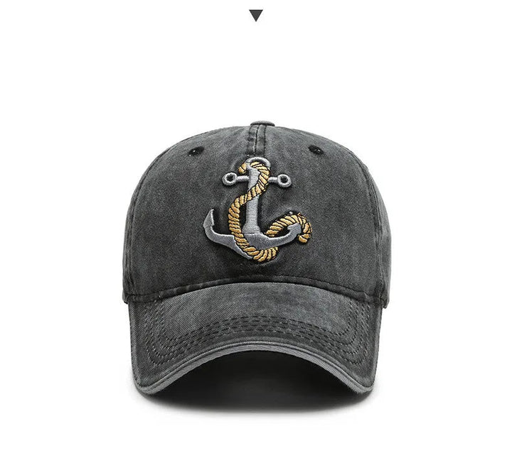 Washed cotton baseball cap featuring a stylish embroidered anchor patch. Unisex, adjustable, perfect for outdoor style.