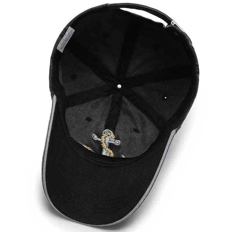 Unisex vintage washed baseball cap. Features an embroidered anchor patch. Adjustable cotton hat for everyday casual wear.