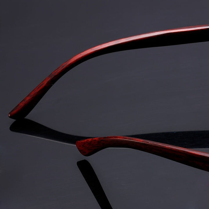 Lightweight Vittoro rimless sunglasses in a studio shot. Highlighting wood temples, unisex appeal, and UV400 lenses.