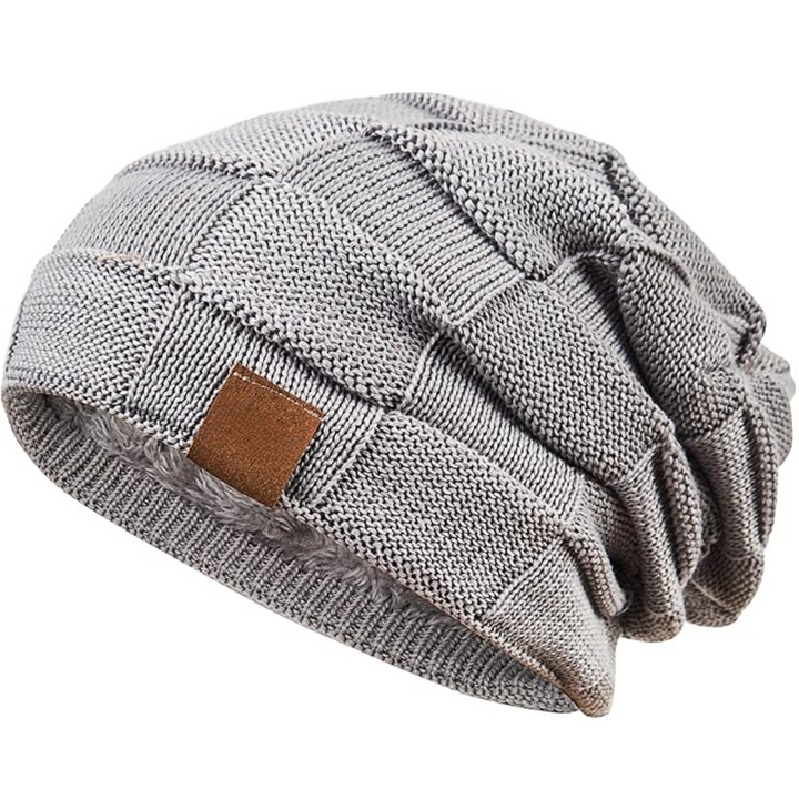 Accessory shot of a folded knitted beanie, ready for travel or everyday use in winter