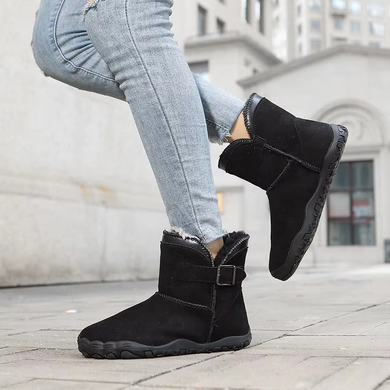 Unisex warm winter barefoot boots, worn outdoors in a snowy landscape, showcasing cold weather protection.