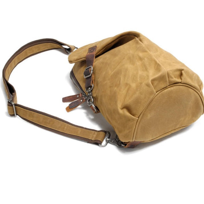 Unisex water-resistant canvas crossbody bag, shown holding phone, wallet, keys. Organized & secure.