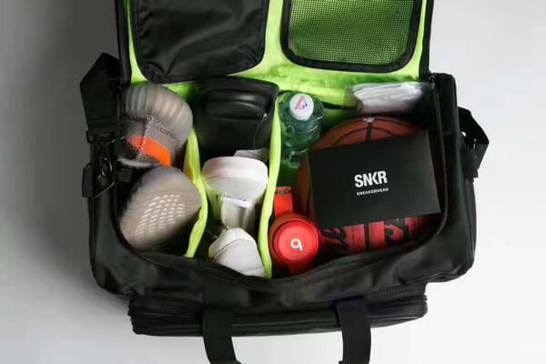 Organized multi-compartment sneaker bag, packed for a weekend getaway or sports event.