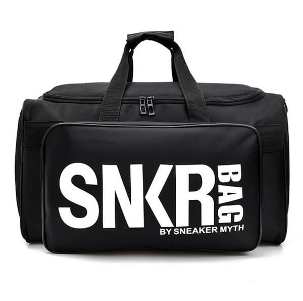 Lifestyle shot of a person carrying the water-resistant sneaker & gear organizer bag