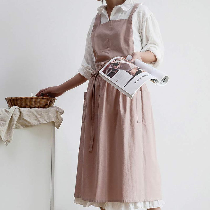 Durable cotton cooking apron, waterproof, featuring large pockets for kitchen tools.
