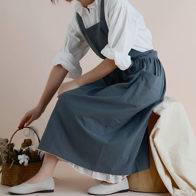 Heavy-duty cotton chef apron, waterproof finish, designed with practical pockets.