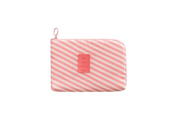 Waterproof pouch for gadgets and cables, zipped shut on a plain background