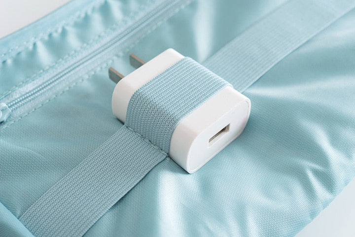 Travel tech organizer, fully packed with various charging cables and adapters