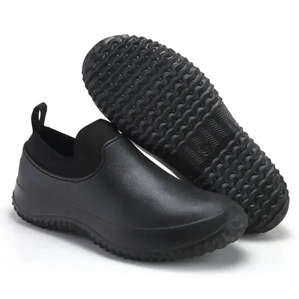 Non-slip outsole of black unisex waterproof work shoes, providing safety & stability for industrial environments.