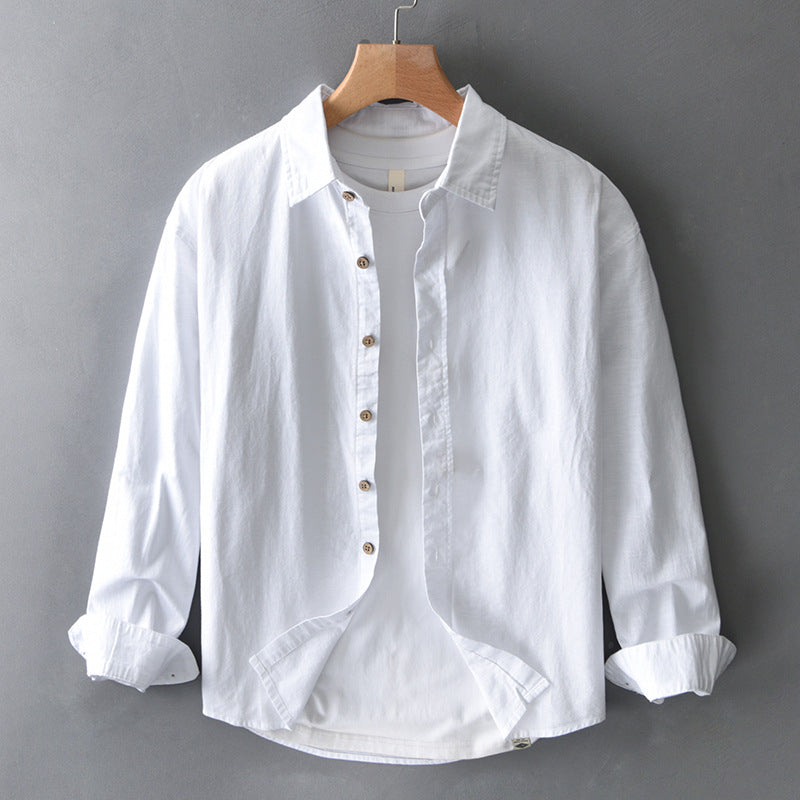Unisex white effortless button-down shirt for everyday comfort, featuring a relaxed fit & versatile style.
