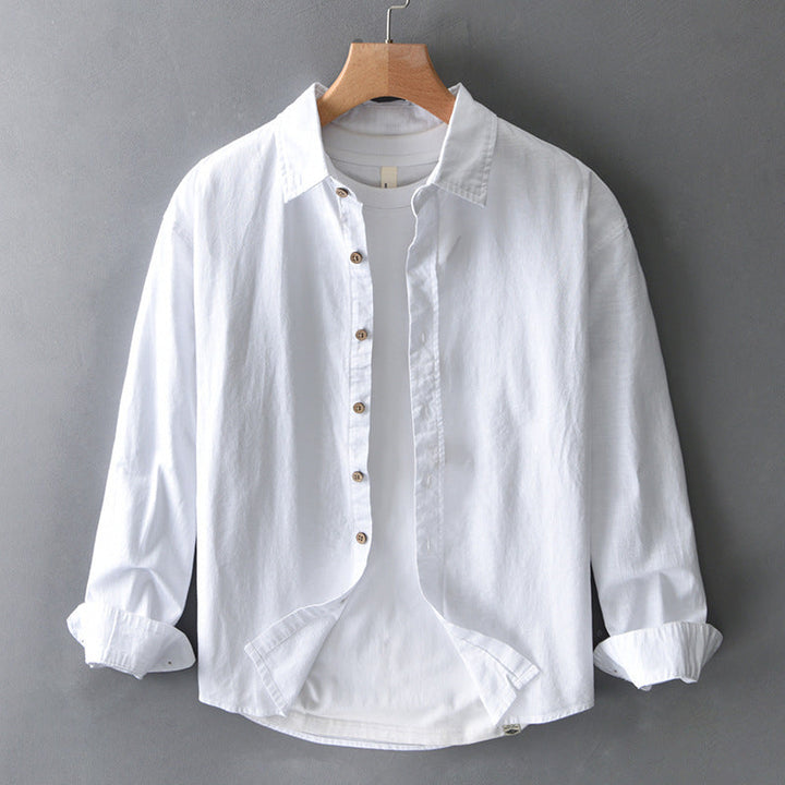 Unisex white effortless button-down shirt for everyday comfort, featuring a relaxed fit & versatile style.