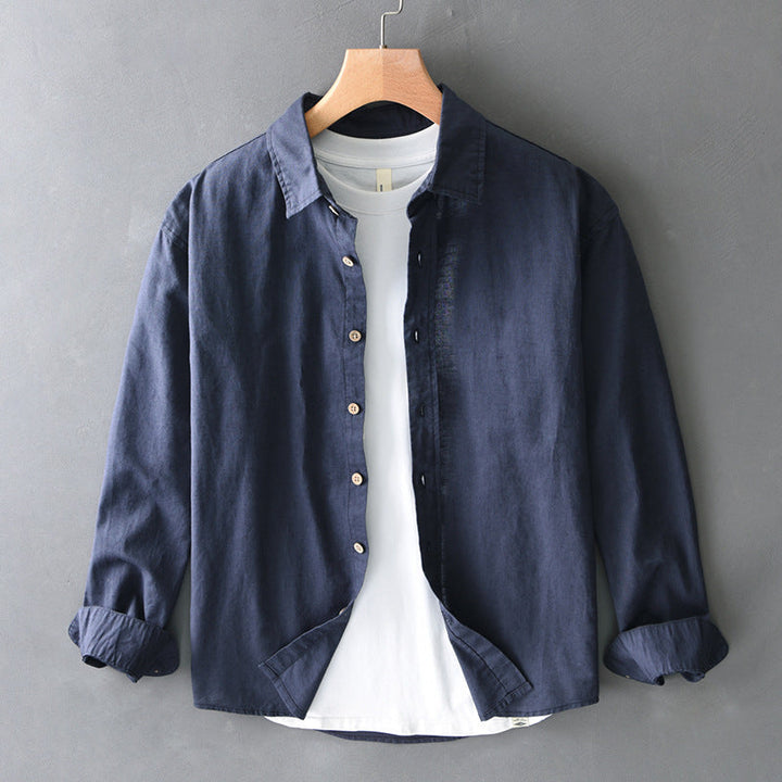 Navy blue unisex button-down shirt designed for everyday comfort with a relaxed fit & casual, versatile style.