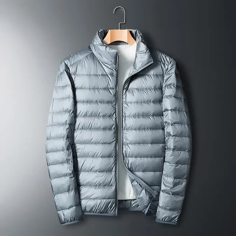 Stylish unisex white packable winter jacket. Lightweight, waterproof, & warm outerwear for men & women in cold weather.