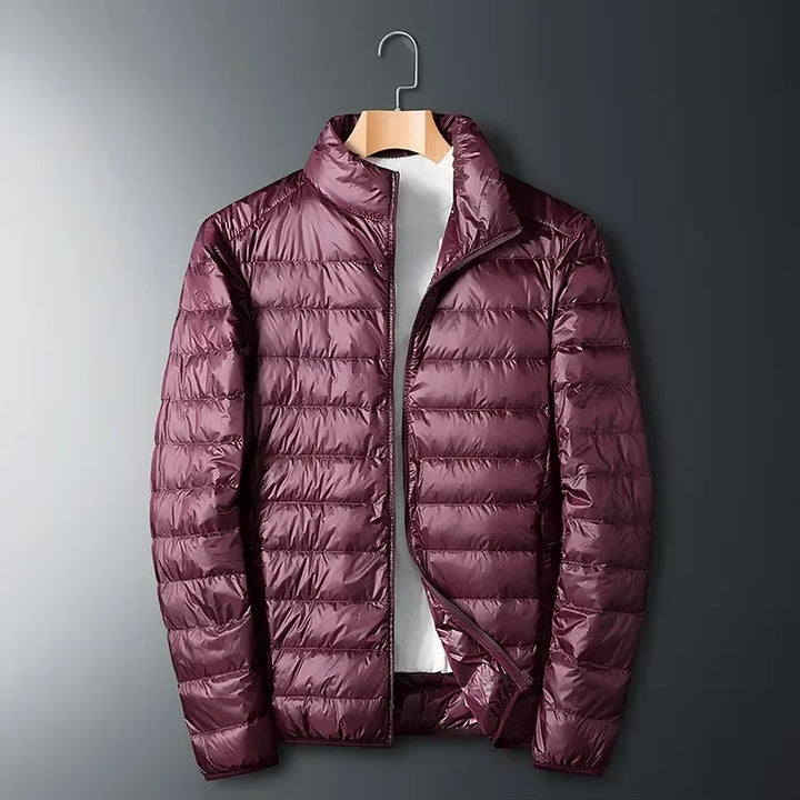 Warm white packable unisex winter jacket. Lightweight, waterproof, & durable cold weather outerwear for daily use.