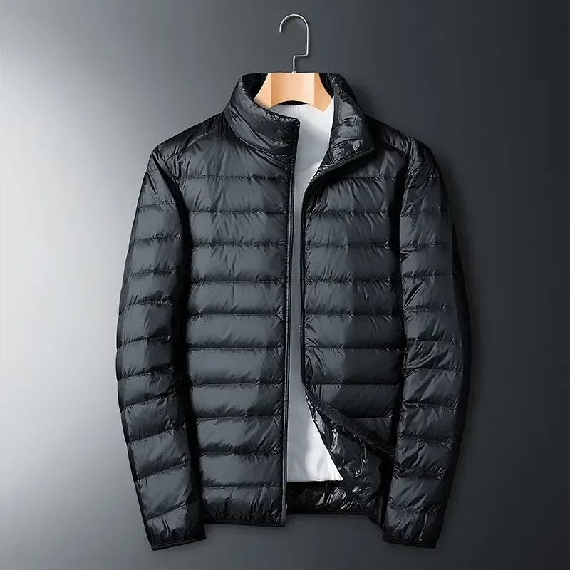 White unisex winter jacket, a packable & lightweight travel essential. Waterproof, durable outerwear for cold weather.