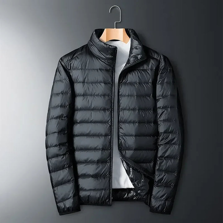 White unisex winter jacket, a packable & lightweight travel essential. Waterproof, durable outerwear for cold weather.