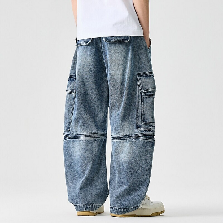 Durable wide-leg unisex denim pants with utility pockets & adjustable waist, ideal for everyday style.