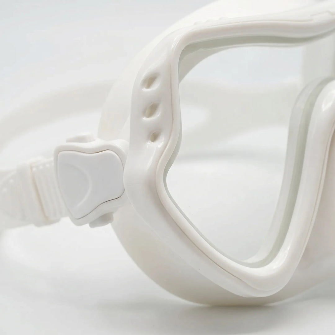 Person wearing unisex wide-view snorkeling mask, exploring vibrant marine life in clear water.