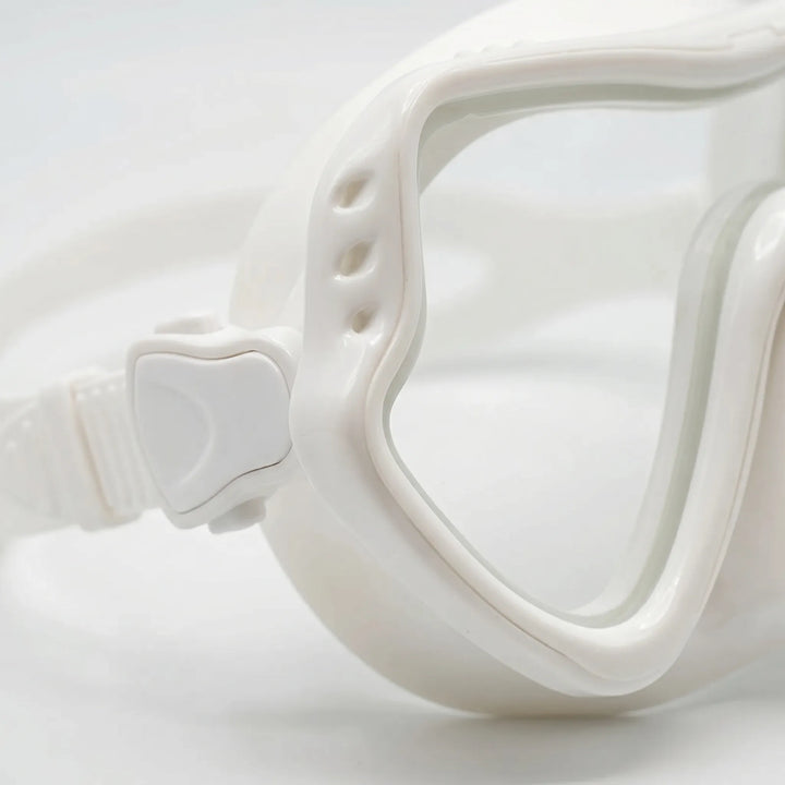 Person wearing unisex wide-view snorkeling mask, exploring vibrant marine life in clear water.