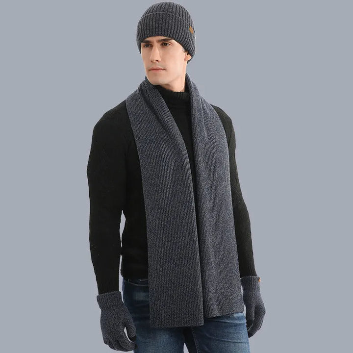 Soft gray knitted hat, scarf, and gloves set, essential unisex winter accessories.