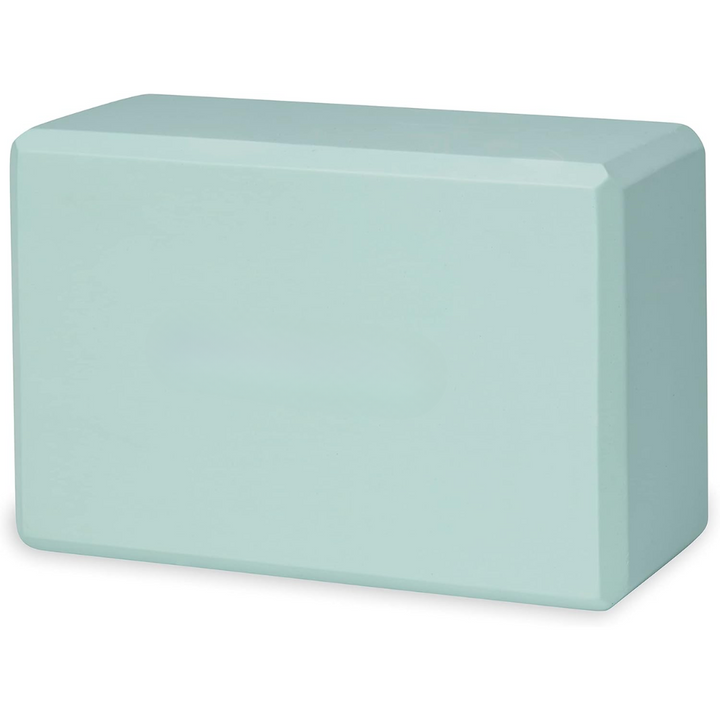 Yogi using a non-slip EVA foam yoga block for stability and extended support in a standing balance pose.