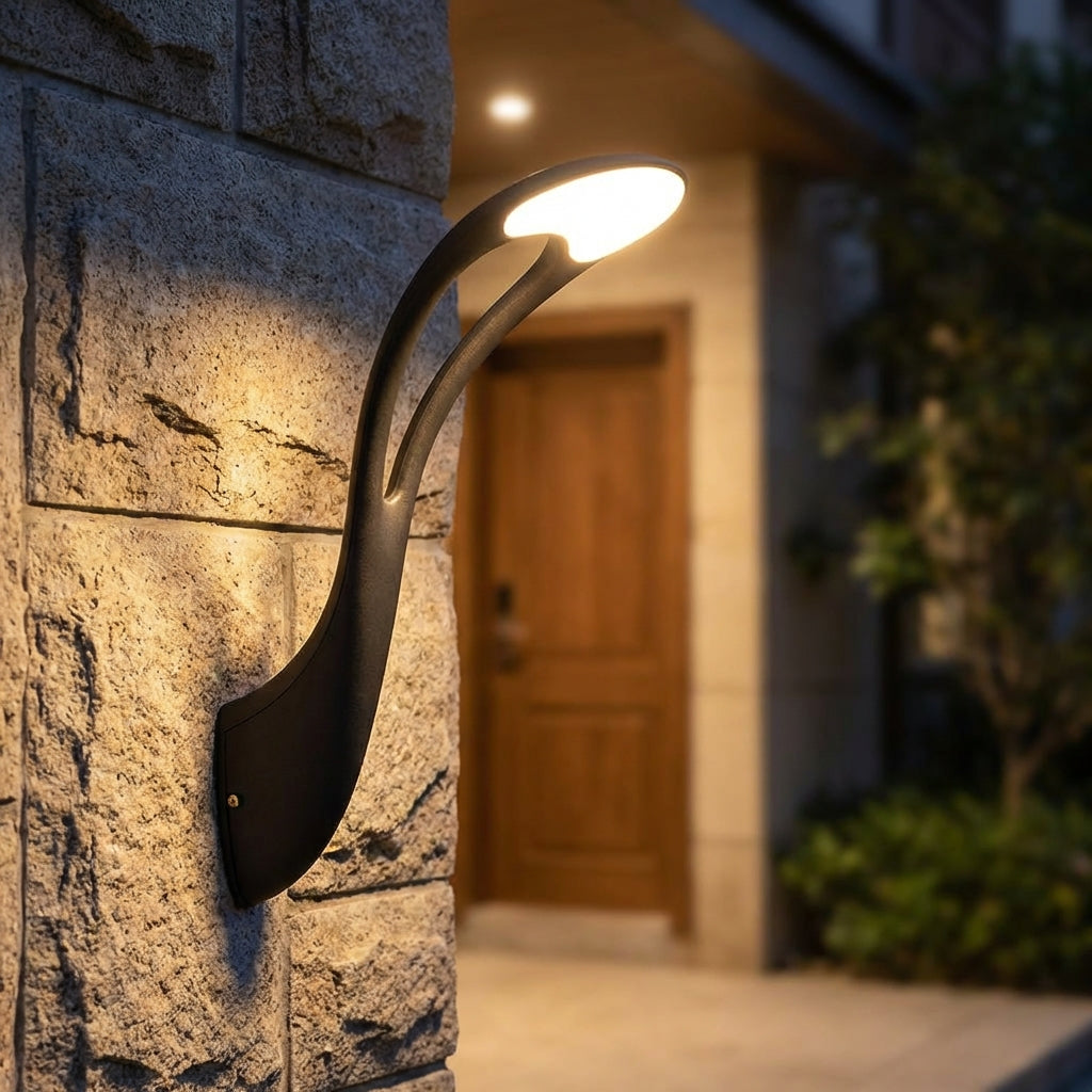 VerdiGlow modern LED outdoor wall sconce, sleek black finish, illuminating a contemporary home exterior.