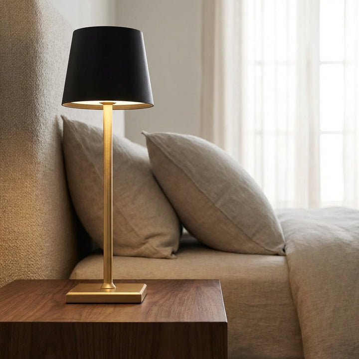 Versatile Cordless Dimmable Table Lamp (Radiovo) on a modern wooden table, providing warm ambient light.