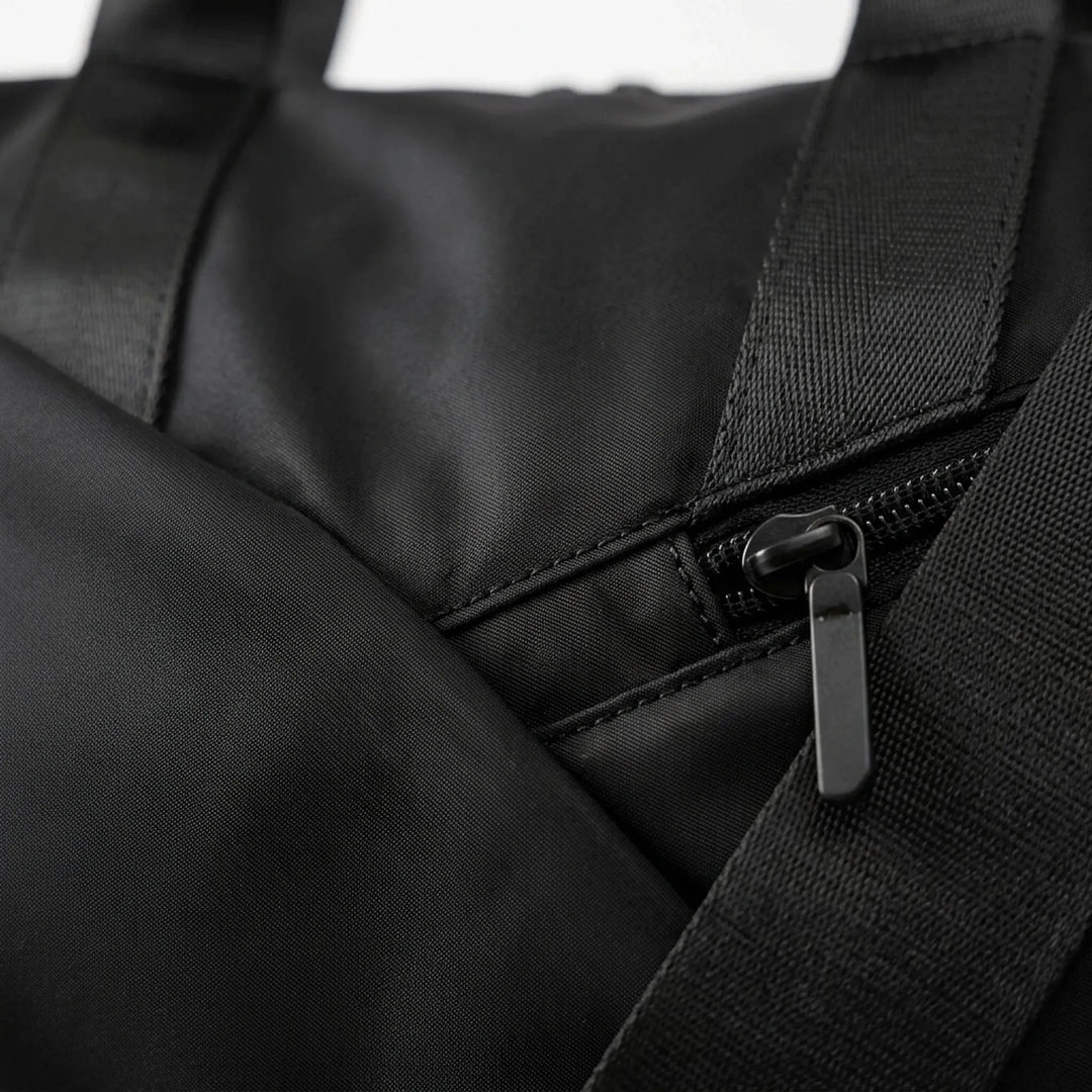 Interior view of the spacious gym duffel bag with organizer pockets for activewear, tech & travel essentials.