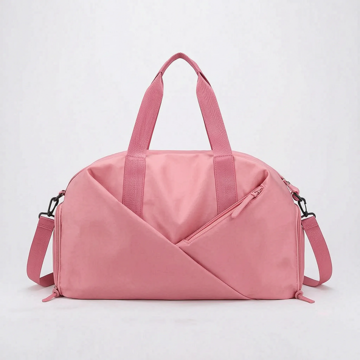 Unisex weekend travel duffel bag, waterproof, carried by a traveler. Ideal for short trips & carry-on.