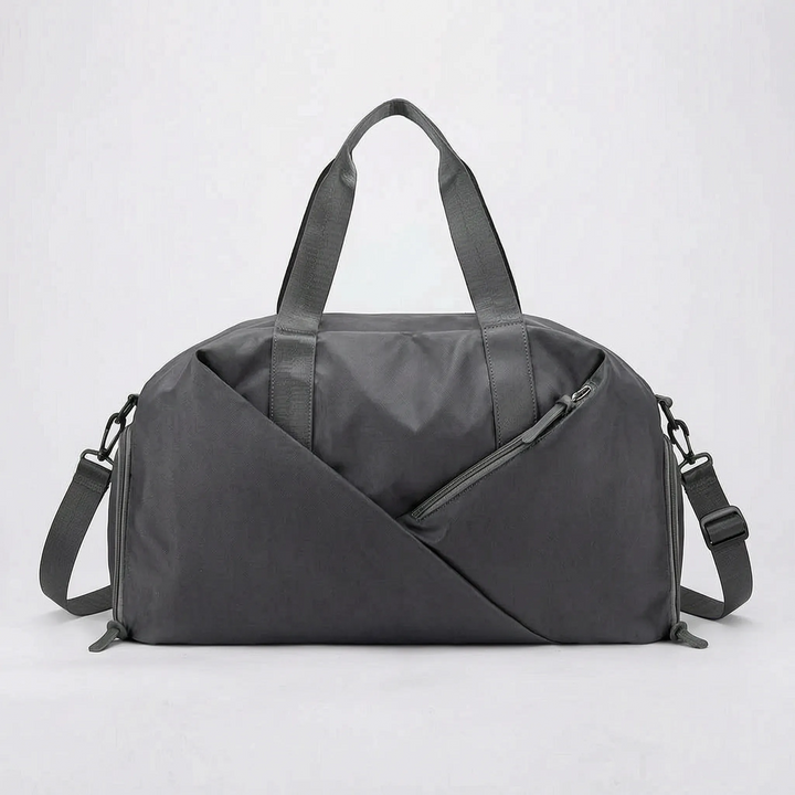 Durable, waterproof material of the black unisex duffel bag, designed for gym, sports & travel in any weather.