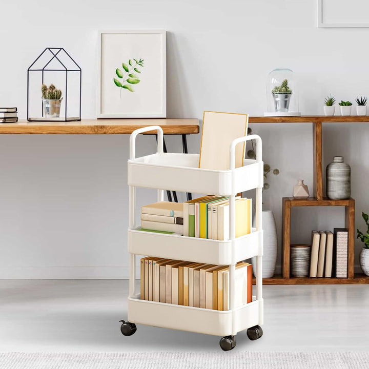 White kitchen storage cart, with handle and wheels, a practical organizing solution.