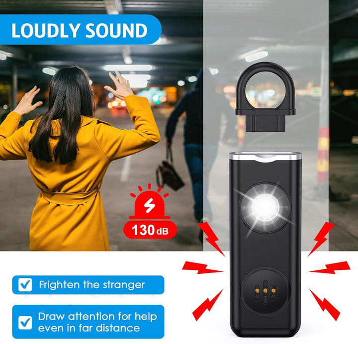Hand holding Veyora 130dB safety alarm keychain, activated with a bright LED light flash