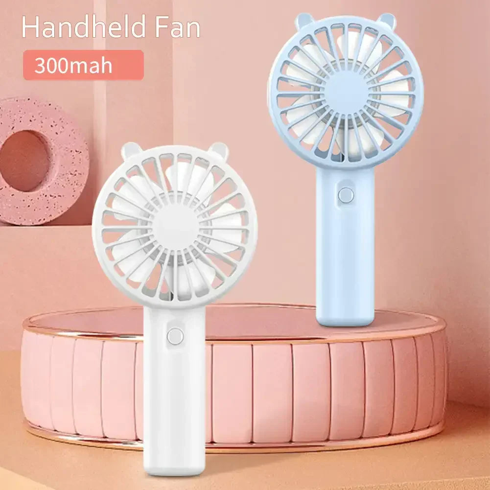 Close-up of the fan blades and protective grill of the Veyra USB rechargeable handheld fan, emphasizing safety