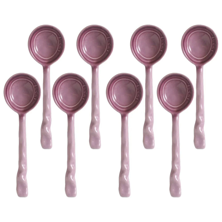 Colorful 8-piece ceramic serving spoon set with unique wavy handles. Durable kitchen utensils.