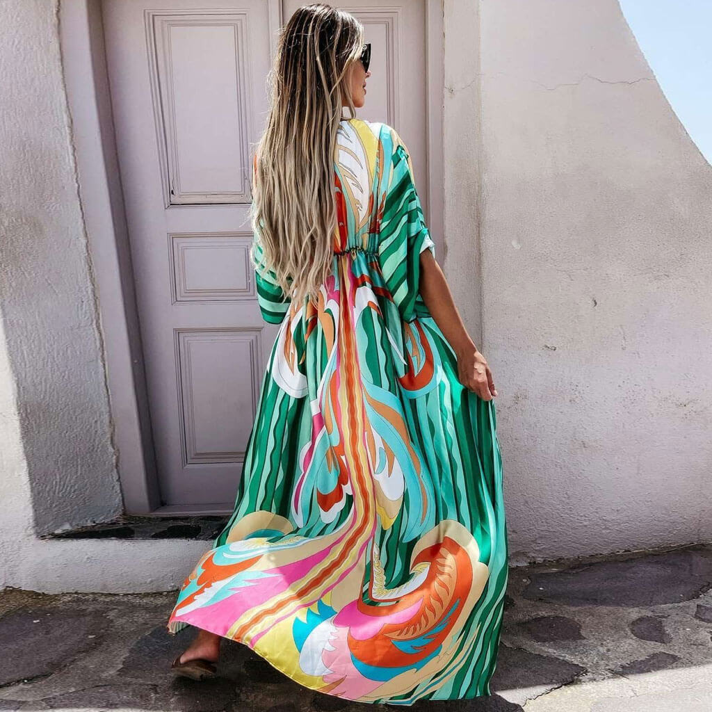 Women's green abstract print maxi vacation dress. Features a flattering v-neck, tie-waist, and flowy button-front design.